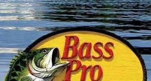 Bass Pro Shops Review: Your One-Stop Outdoor Gear Destination Angler using Bass Pro Shops fishing gear on a lake at sunrise